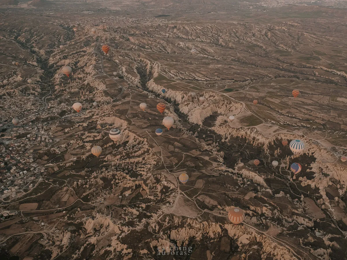 Hot Air Balloons fly over Cappadocia's unique landscape in this "Guide to Cappadocia" post.