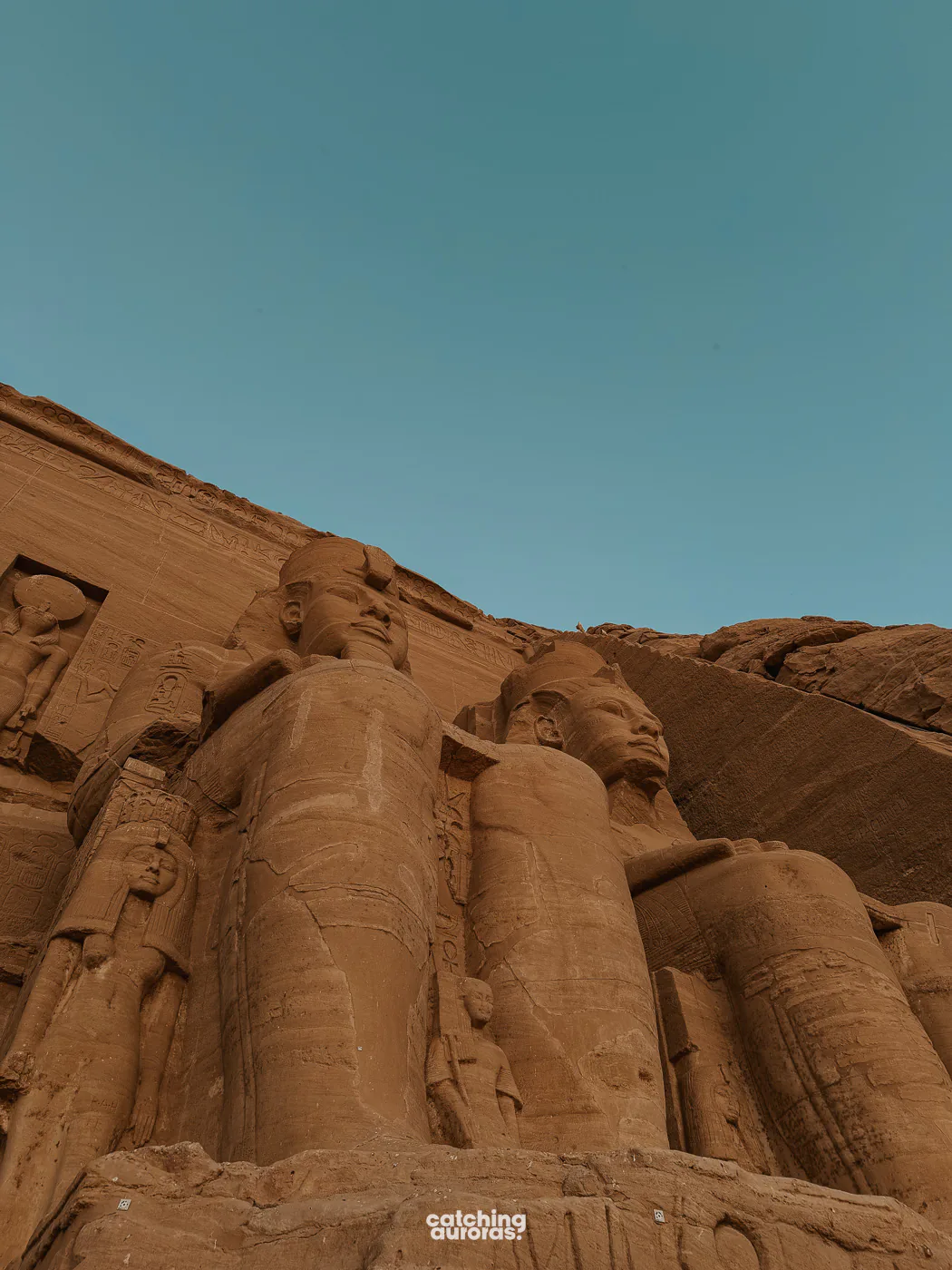 Faces of two seated colossi of Ramesses II at dawn, Great Temple of Abu Simbel