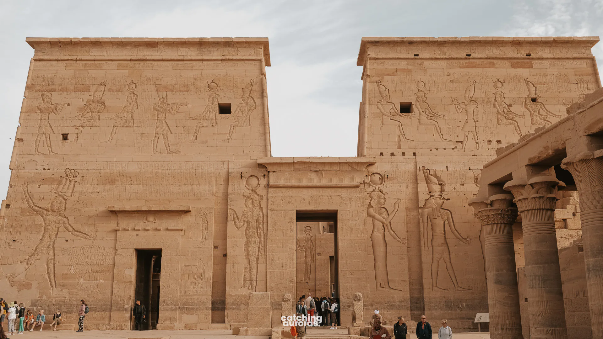 First pylon of the Temple of Isis at Philae, with reliefs of Ptolemy attacking enemies, Aswan, Egypt.