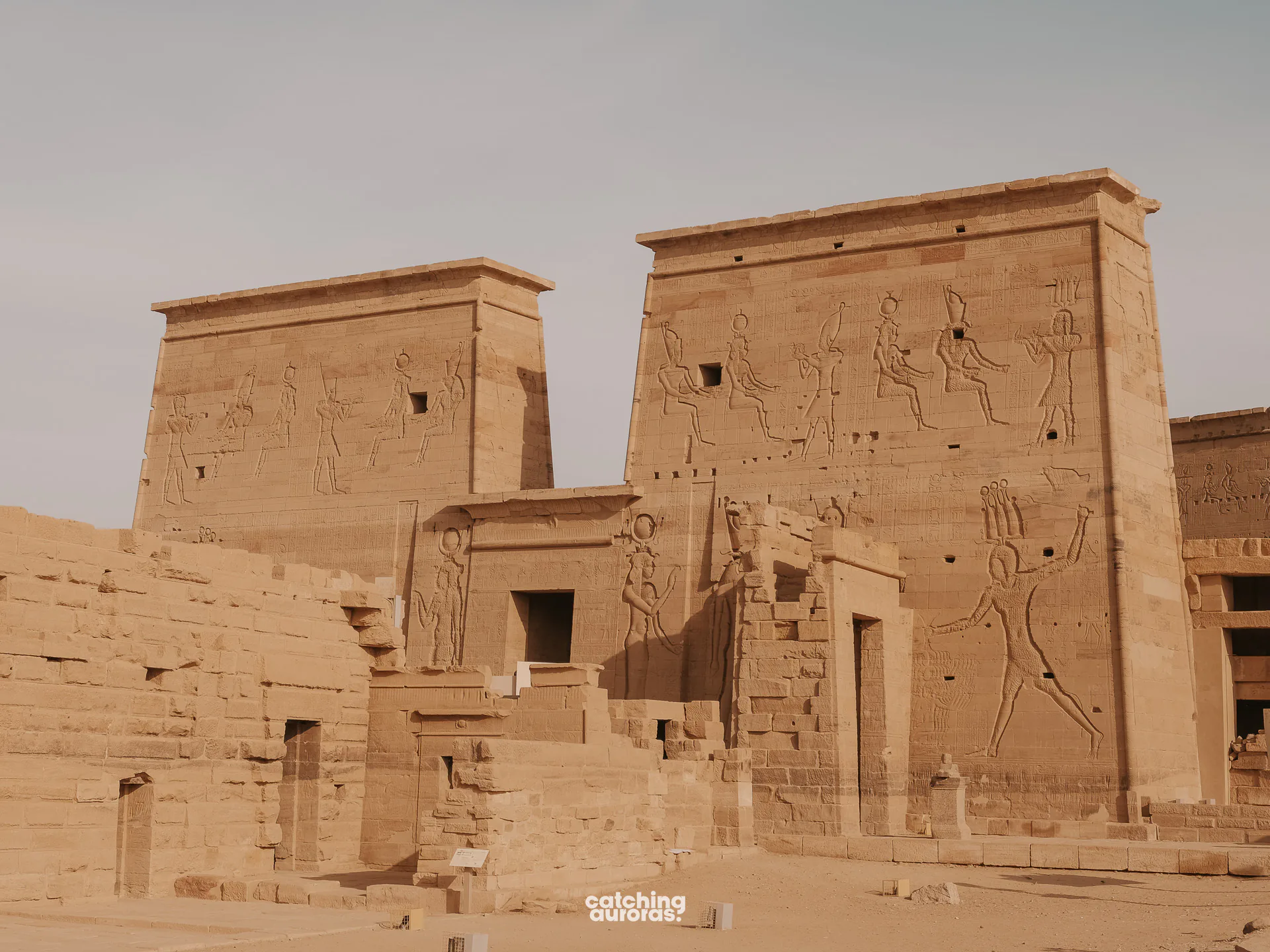 First pylon of the Temple of Isis at Philae, with reliefs of Ptolemy attacking enemies, Aswan, Egypt.