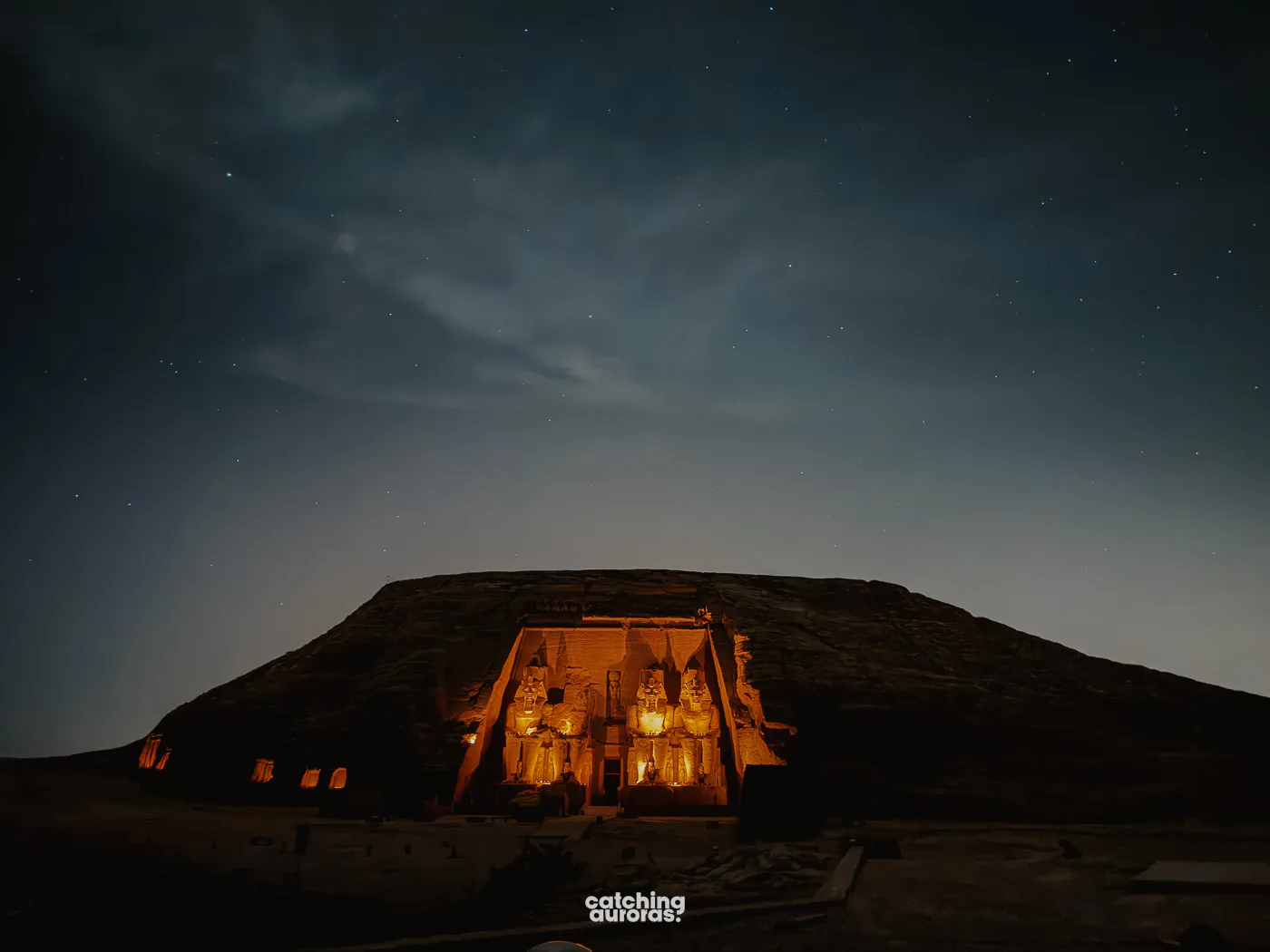Great Temple of Abu Simbel under coloured projections at night, seen from the audience seating during Sound and Light Show