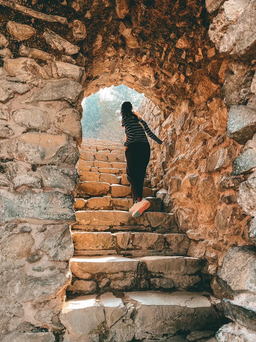 A girl walks up the staircase in Pari Mahal.