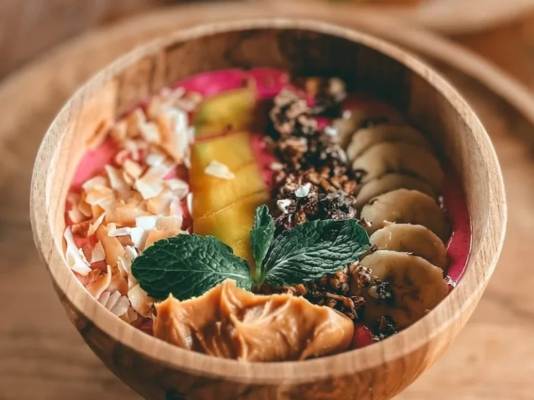 A photo of a smoothie bowl filled with fruits and coconut