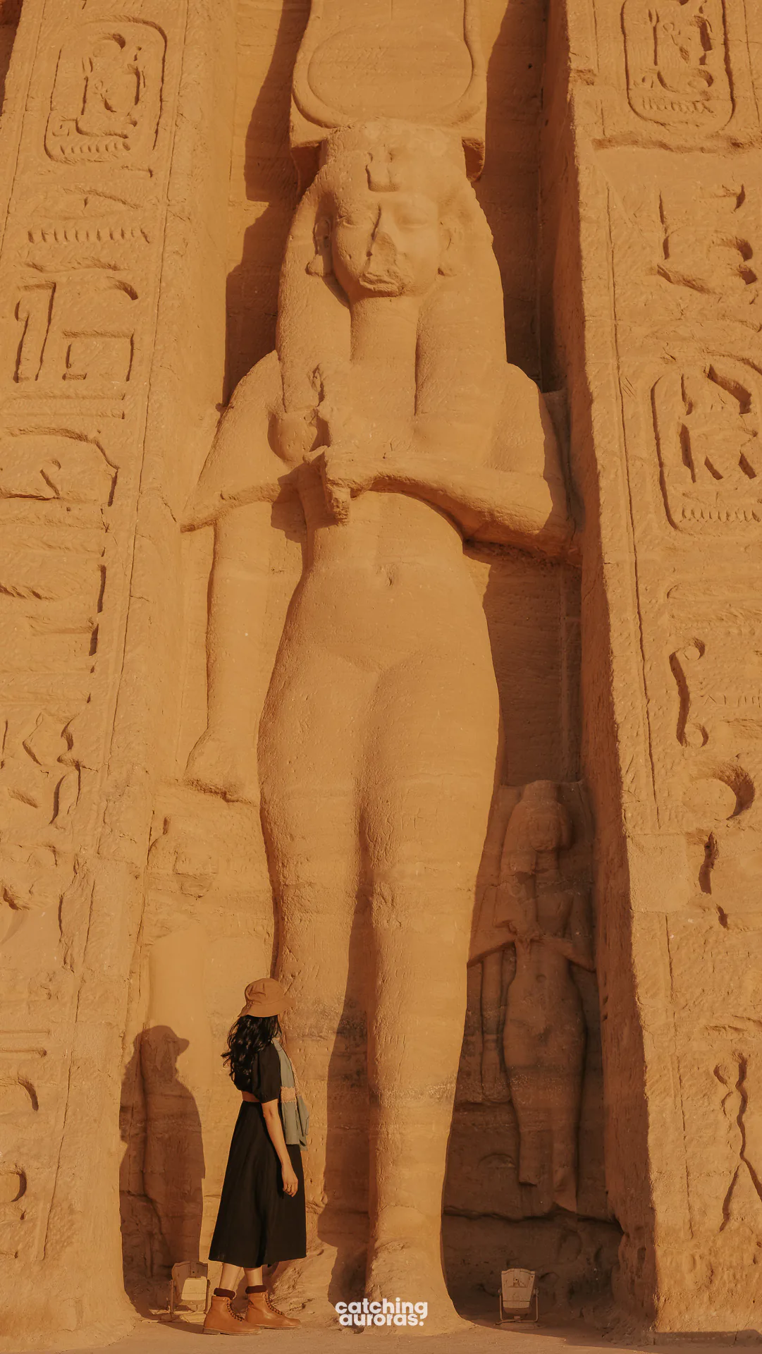 Traveller beside a standing statue of Queen Nefertari, Small Temple, Abu Simbel