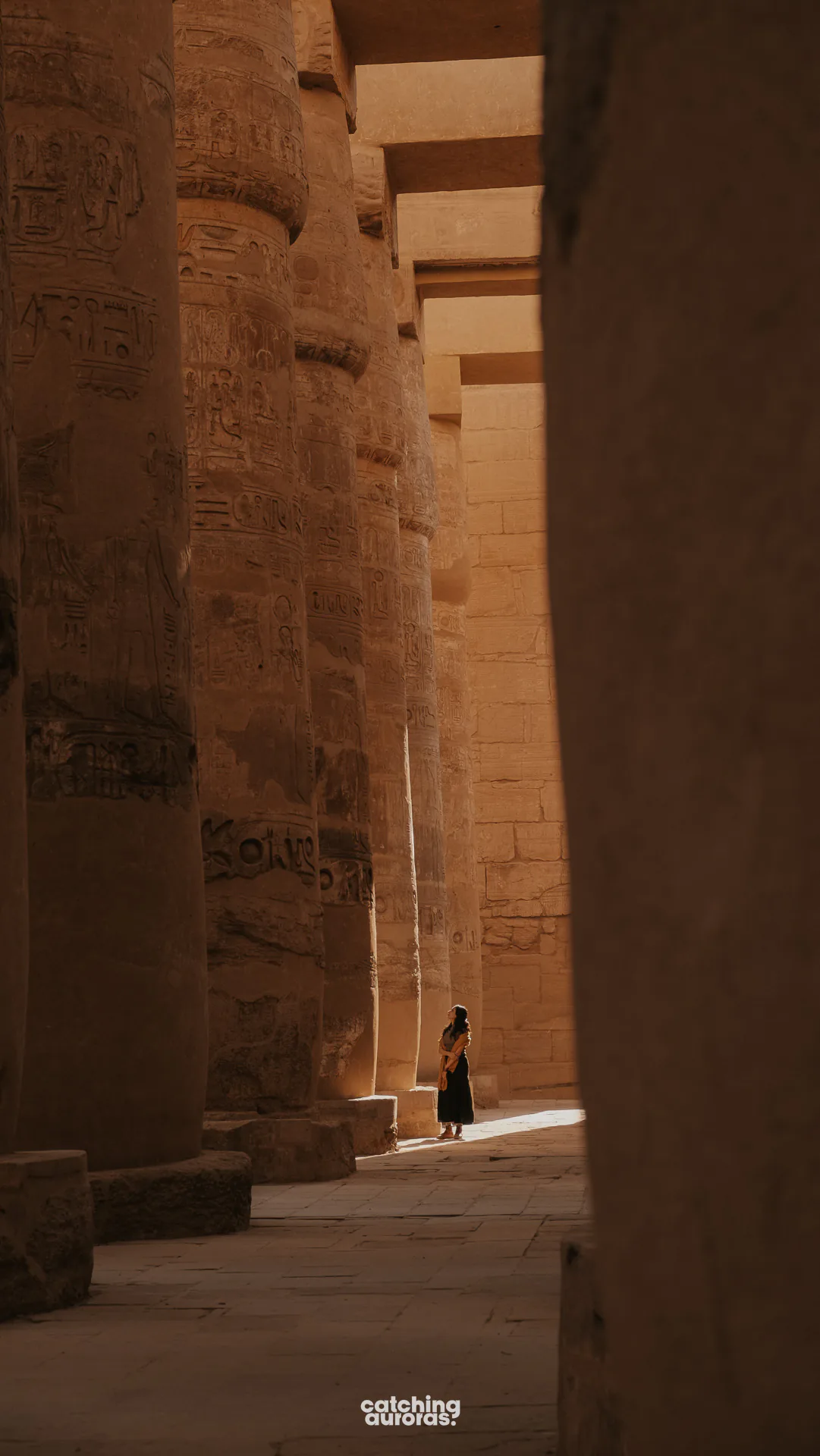 Walking amidst the Hypostyle Hall in Karnak Temple in Luxor, Egypt
